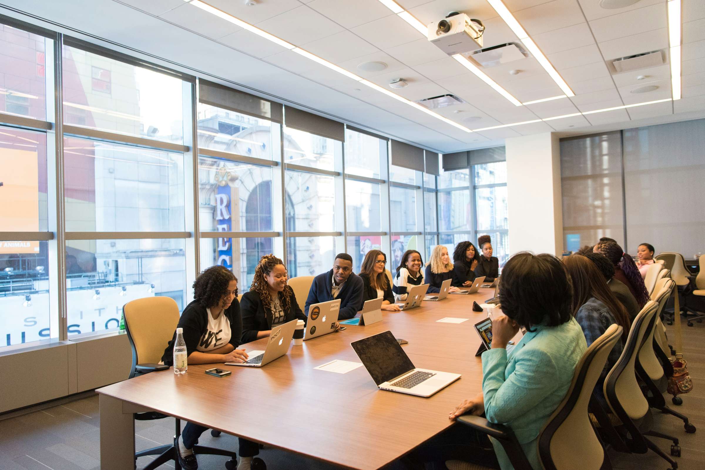 group of people on both sides of a long table