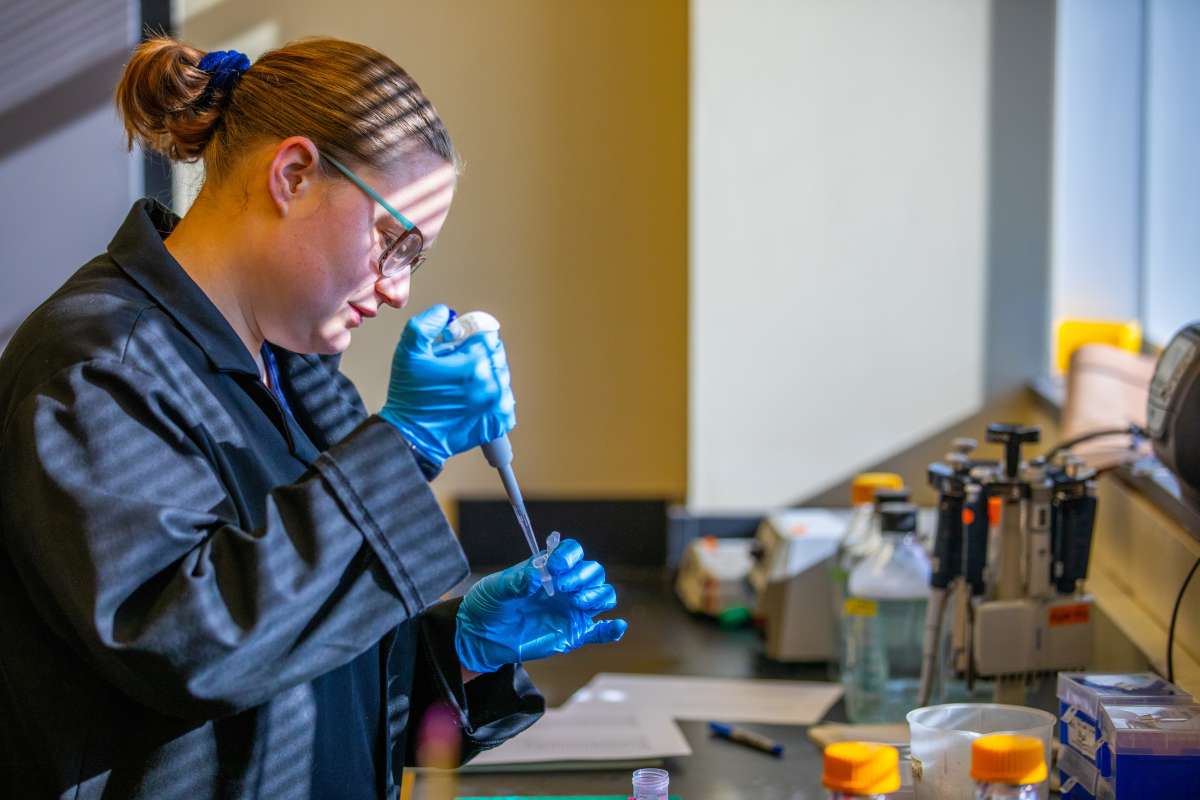 women using pipet for science research 