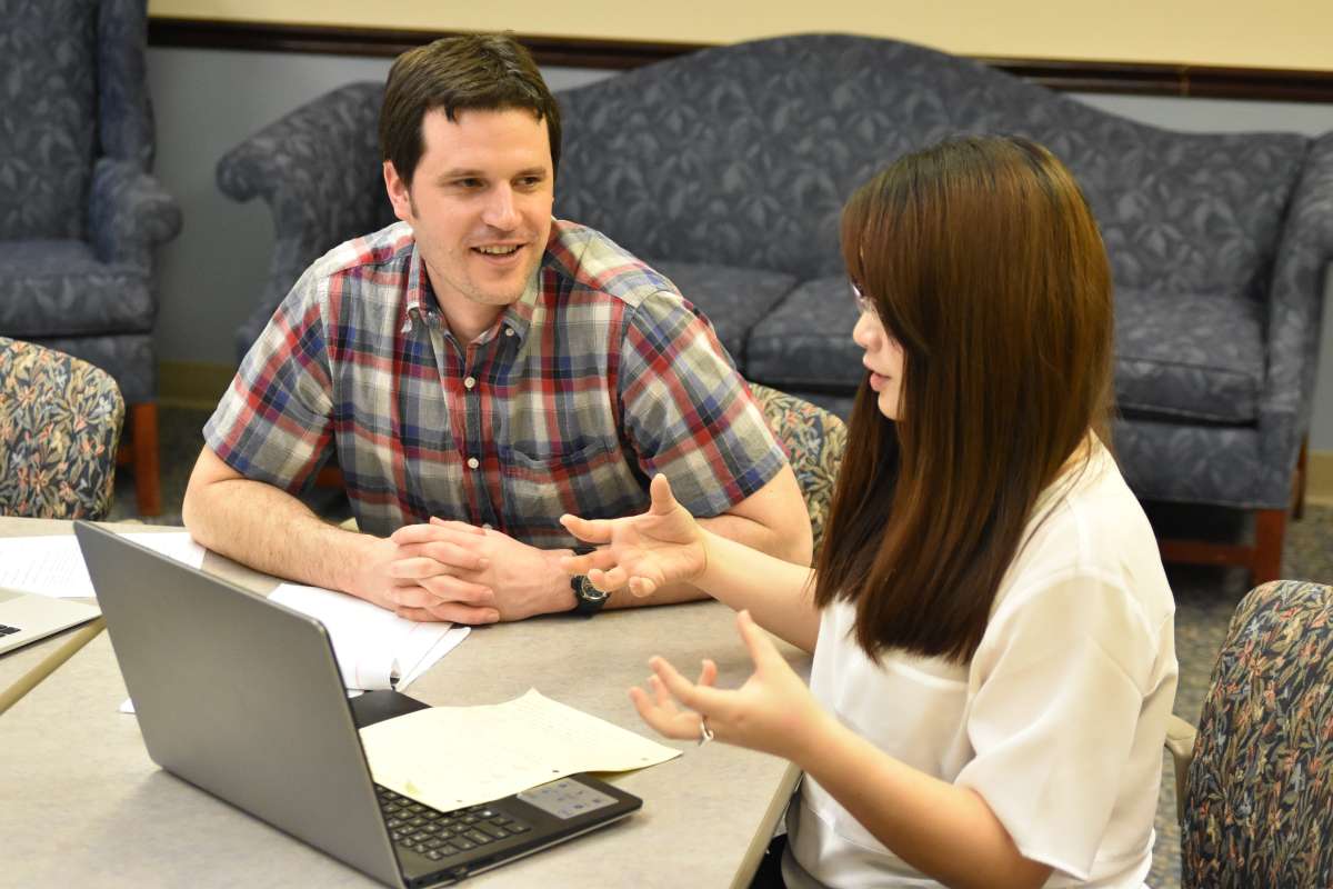 Two graduate students duting a communication consultation