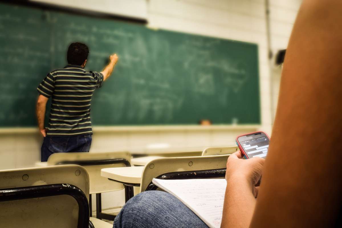 man writing on chalkboard